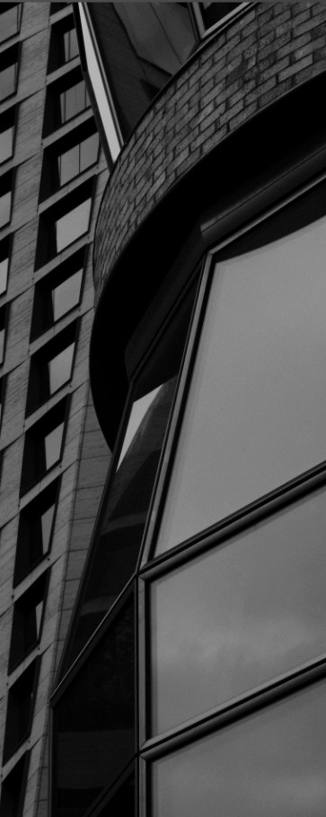 Tall brick building facade in black and white